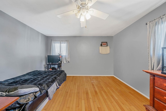 bedroom with ceiling fan and light hardwood / wood-style flooring