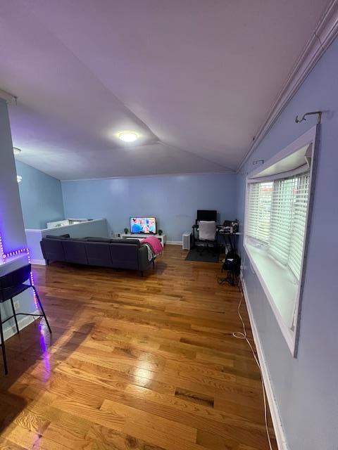 bedroom with vaulted ceiling and light hardwood / wood-style floors