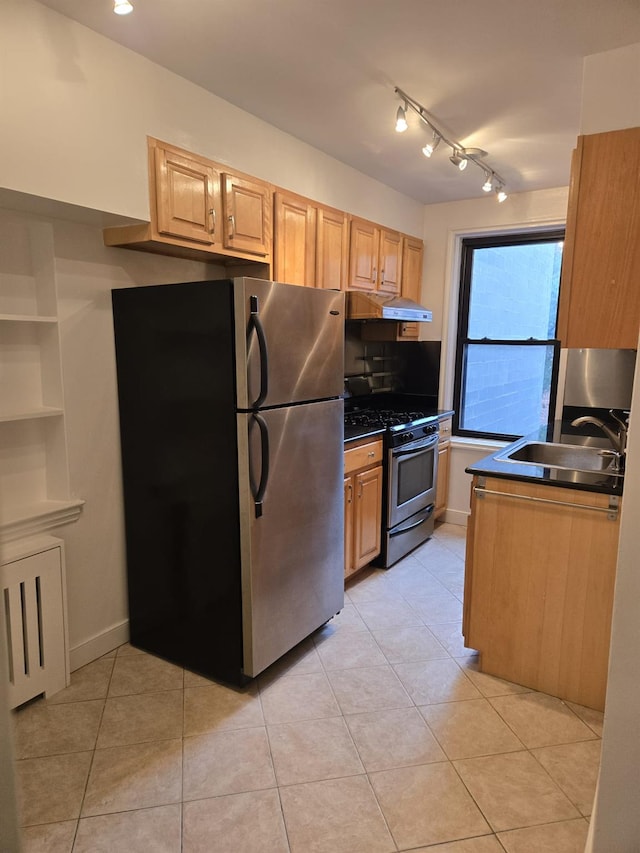 kitchen featuring light tile patterned flooring, sink, light brown cabinets, track lighting, and stainless steel appliances