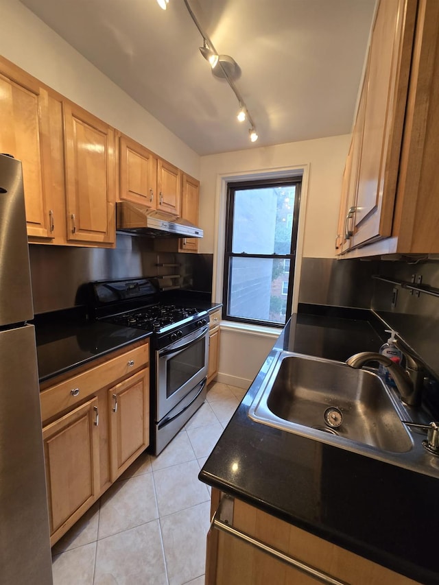 kitchen featuring appliances with stainless steel finishes, sink, and light tile patterned floors