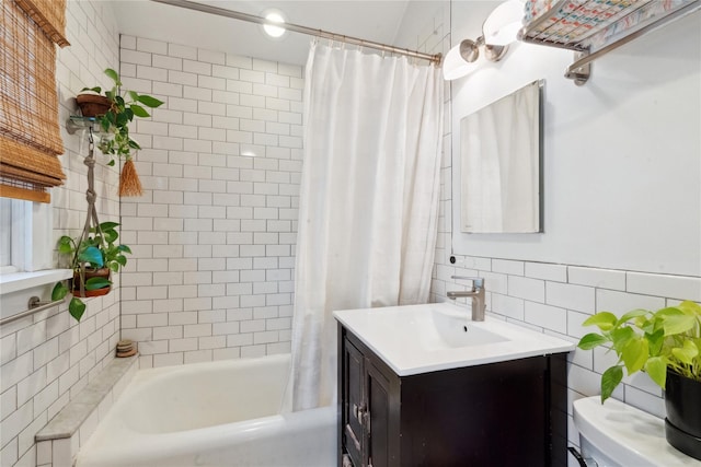 bathroom featuring toilet, vanity, tile walls, and shower / tub combo with curtain