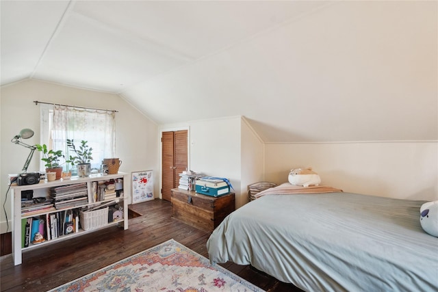 bedroom with dark wood-style floors and lofted ceiling