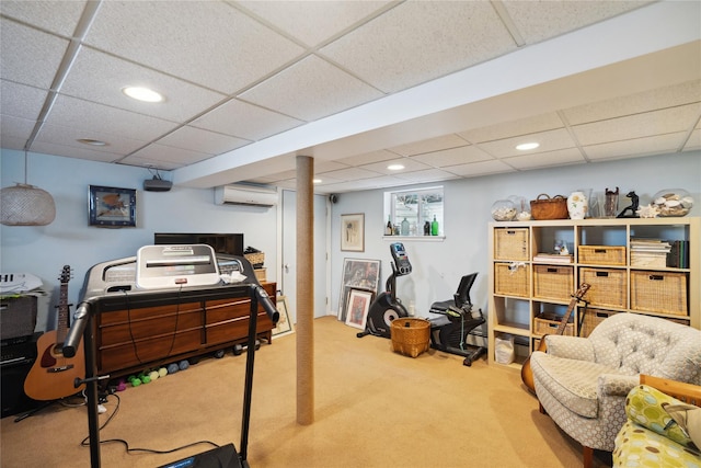 interior space featuring light carpet, a drop ceiling, a wall mounted air conditioner, and recessed lighting