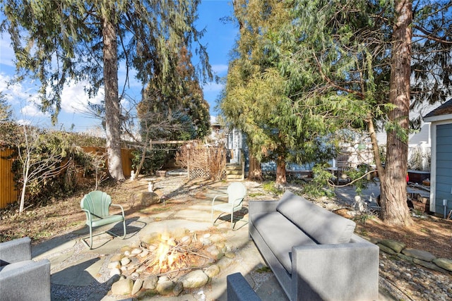 view of patio featuring an outdoor living space with a fire pit