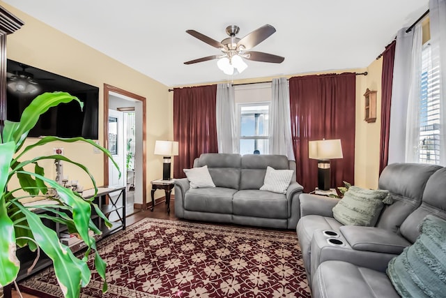 living room with ceiling fan and wood finished floors