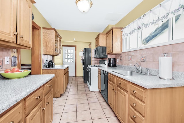 kitchen featuring light tile patterned floors, a sink, light countertops, black appliances, and backsplash