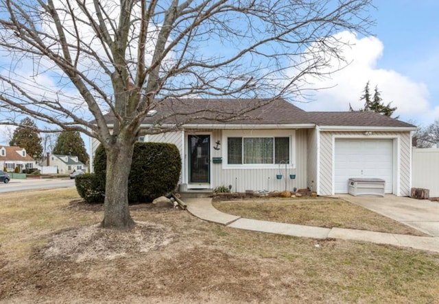 single story home featuring a garage and a front lawn