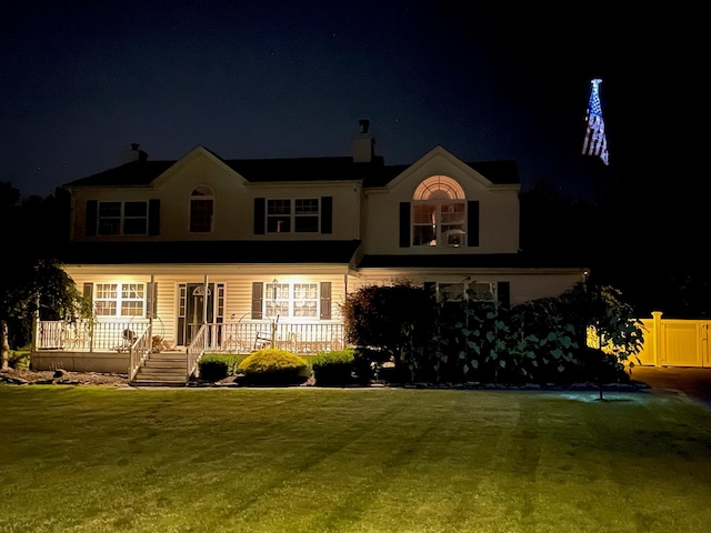 view of front of property featuring a yard and fence