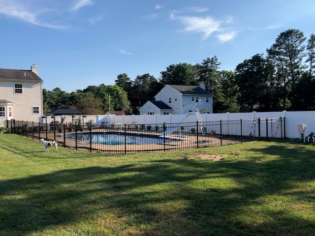 view of yard with fence, a fenced in pool, and a gazebo