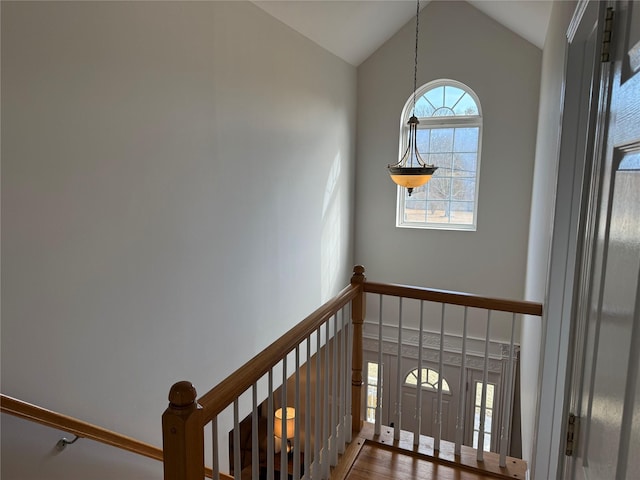 staircase with high vaulted ceiling