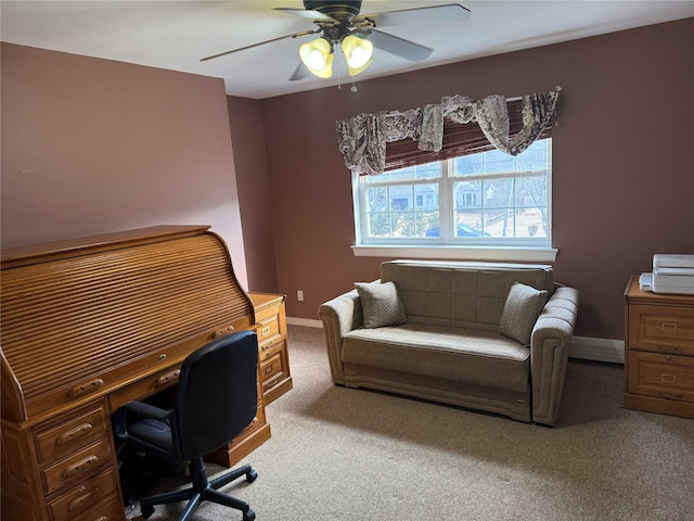 carpeted office with a ceiling fan and baseboards