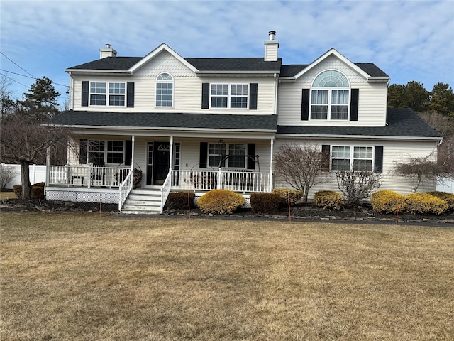 view of front of property with covered porch, roof with shingles, a chimney, and a front yard