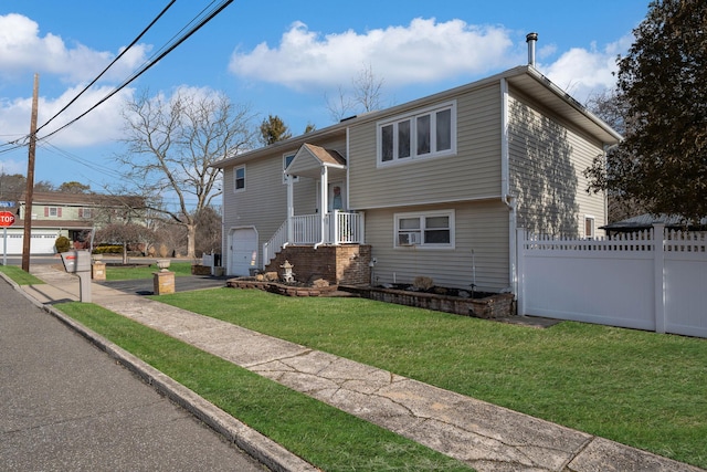 bi-level home with a garage and a front yard