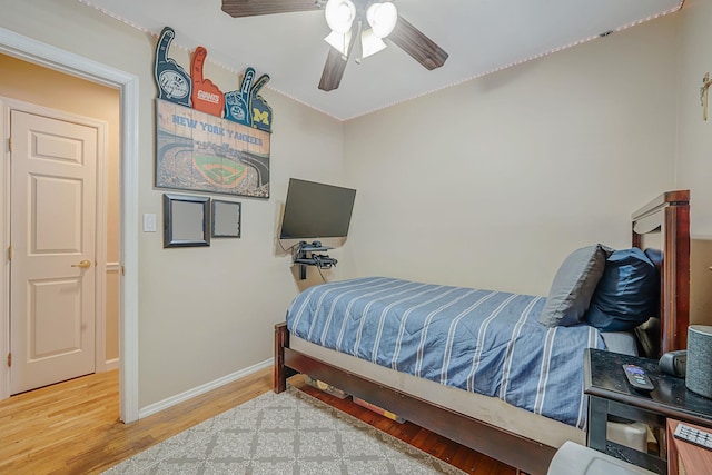 bedroom with hardwood / wood-style floors and ceiling fan