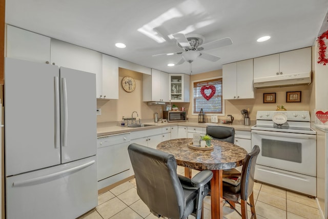 kitchen with sink, white cabinets, light tile patterned floors, ceiling fan, and white appliances