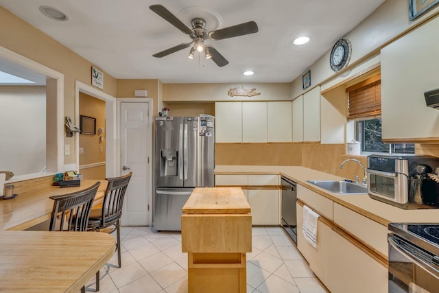 kitchen featuring black dishwasher, sink, wooden counters, a center island, and stainless steel refrigerator with ice dispenser