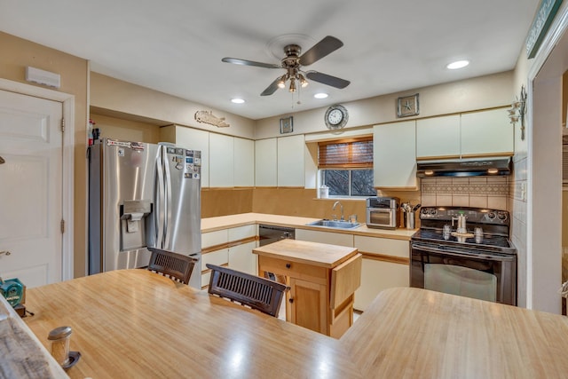 kitchen featuring extractor fan, butcher block countertops, sink, stainless steel fridge, and electric range