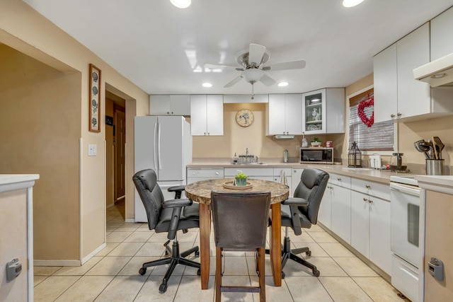 kitchen featuring sink, light tile patterned floors, white cabinets, and white appliances