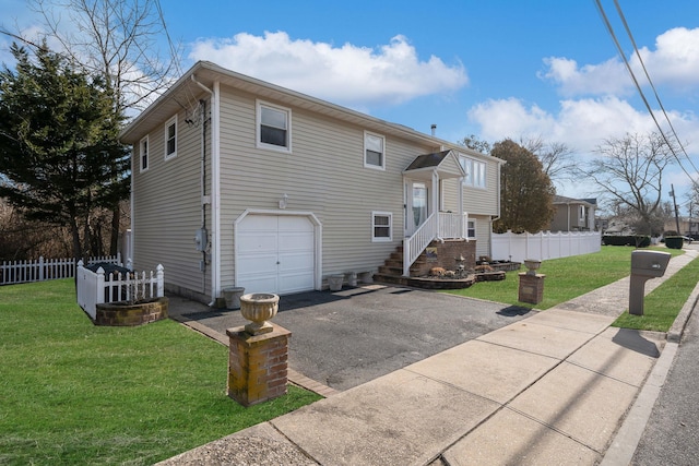 bi-level home with a garage and a front yard