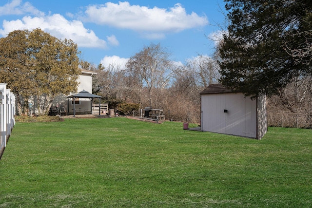 view of yard with a gazebo and a storage shed