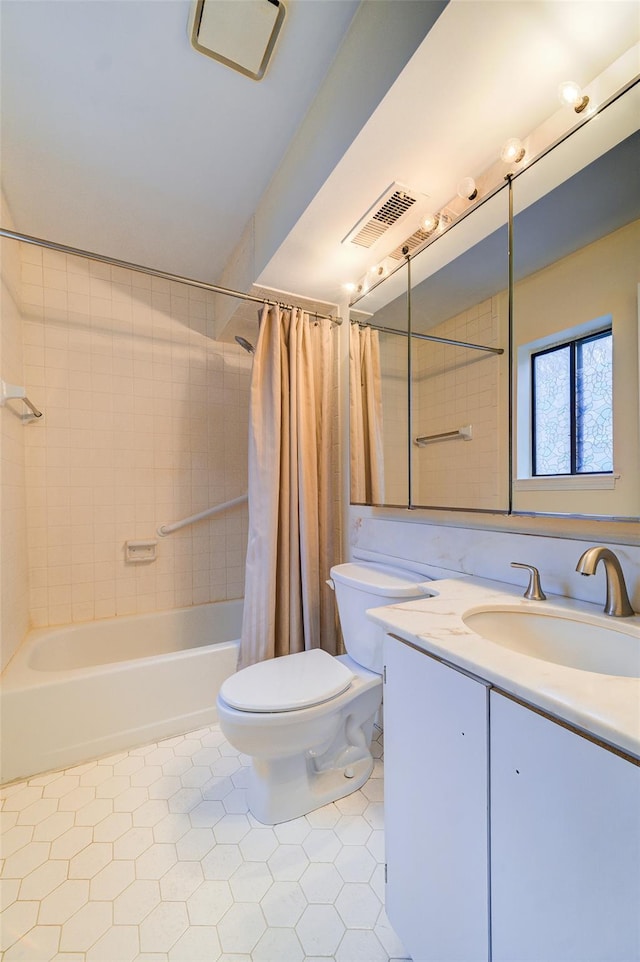 full bathroom with vanity, shower / tub combo with curtain, tile patterned floors, and toilet