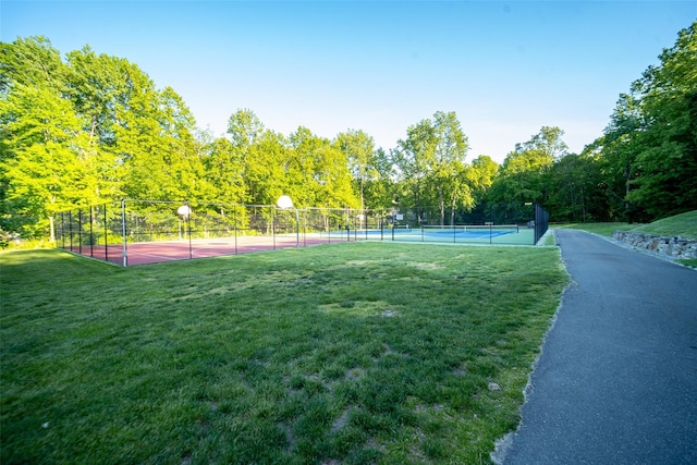 view of sport court with basketball court and a yard