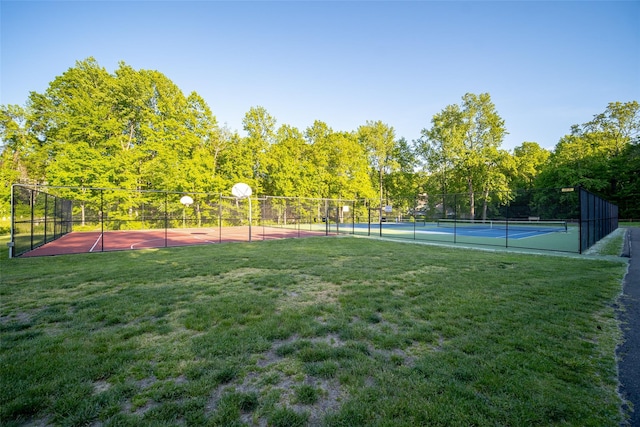 view of sport court with basketball court and a yard