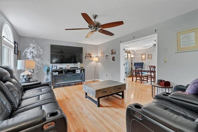 living room featuring ceiling fan and wood-type flooring