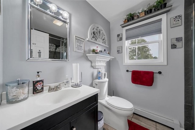 bathroom featuring baseboard heating, vanity, toilet, and a shower