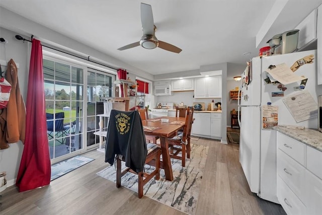 dining room with ceiling fan and light hardwood / wood-style floors