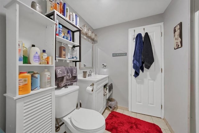 bathroom with tile patterned flooring, vanity, and toilet