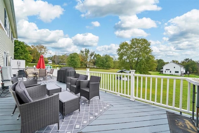 wooden deck with an outdoor living space, a yard, and a grill