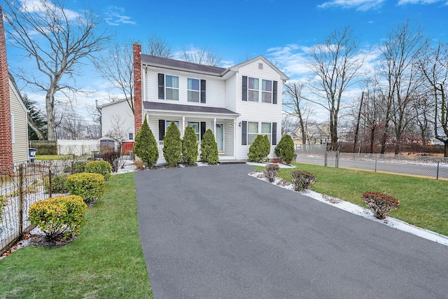 view of front of property with a porch and a front yard