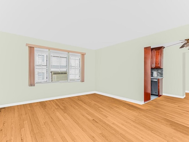 unfurnished room featuring ceiling fan and light hardwood / wood-style floors