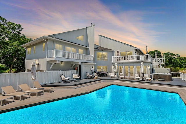 pool at dusk with a patio