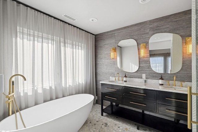 bathroom with vanity and a bathtub