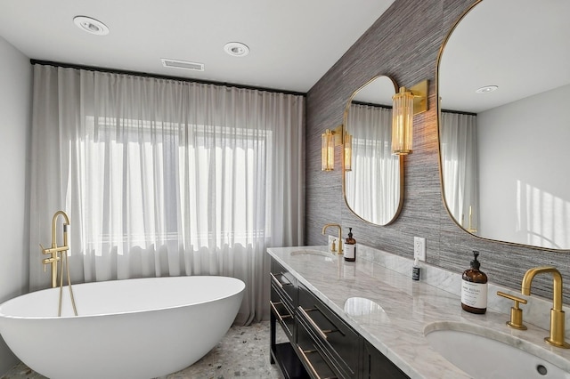 bathroom featuring vanity and a tub