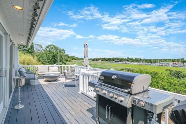 deck featuring a grill and an outdoor hangout area