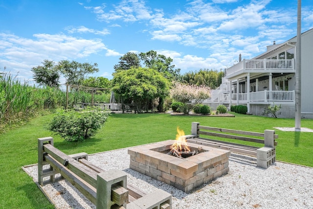 view of home's community with a yard and a fire pit