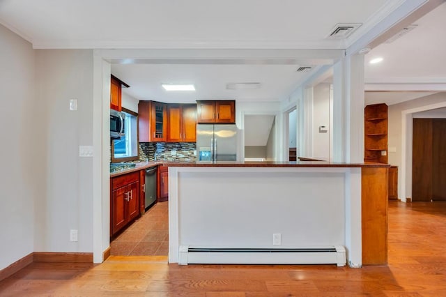 kitchen featuring tasteful backsplash, appliances with stainless steel finishes, light wood-type flooring, and a baseboard heating unit