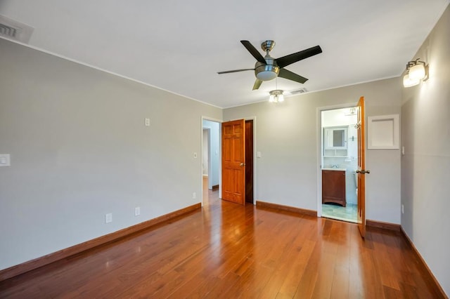 spare room featuring wood-type flooring and ceiling fan