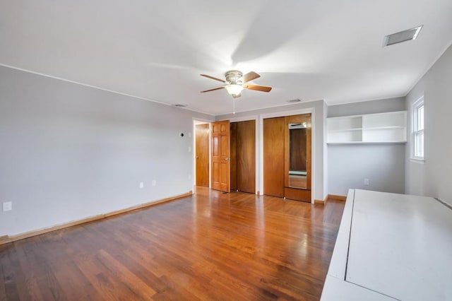 interior space with wood-type flooring and ceiling fan