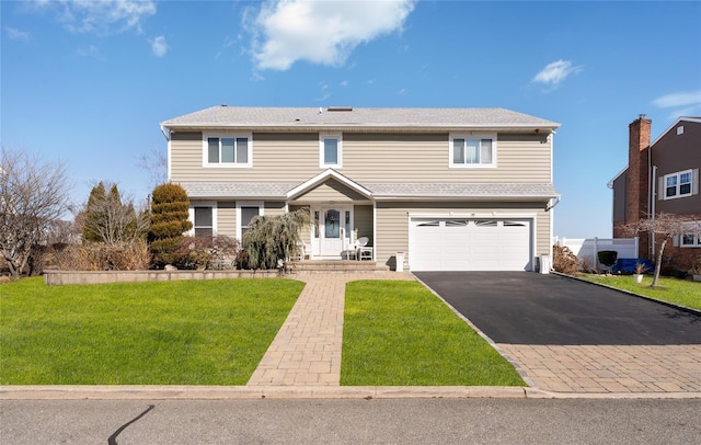 front of property with a garage, central AC unit, and a front yard