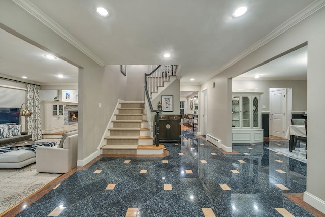 stairway featuring crown molding, a stone fireplace, and baseboard heating