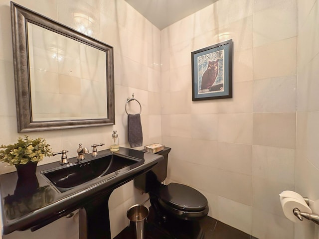 bathroom featuring tile walls, sink, tile patterned flooring, and toilet