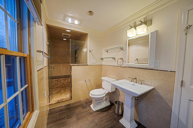 bathroom with crown molding, tile walls, an enclosed shower, and toilet