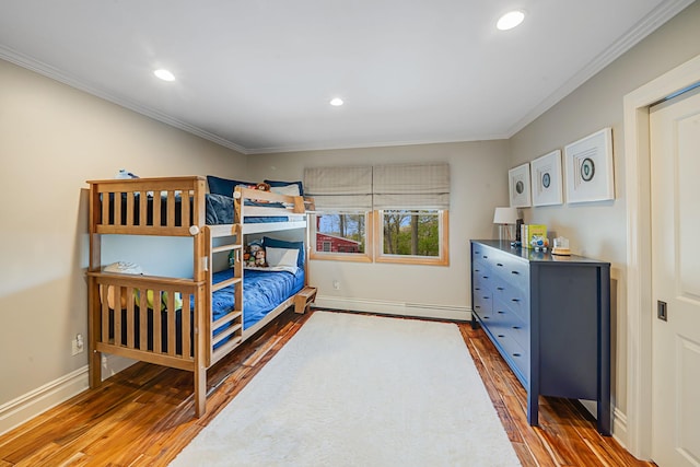 bedroom with crown molding and dark hardwood / wood-style floors