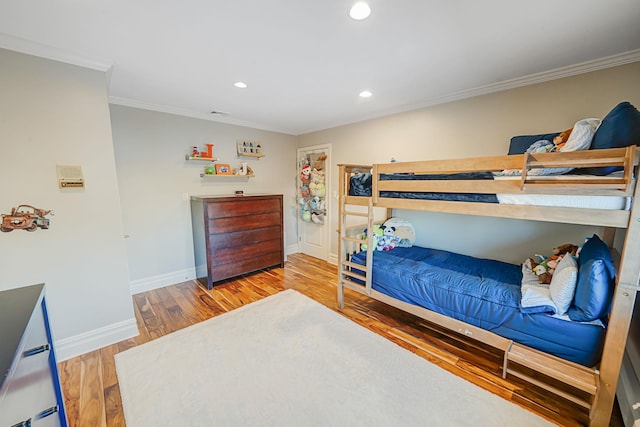 bedroom featuring hardwood / wood-style flooring and crown molding