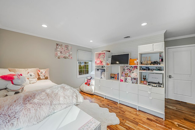 bedroom with crown molding and light wood-type flooring