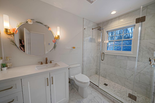 bathroom featuring vanity, toilet, and an enclosed shower